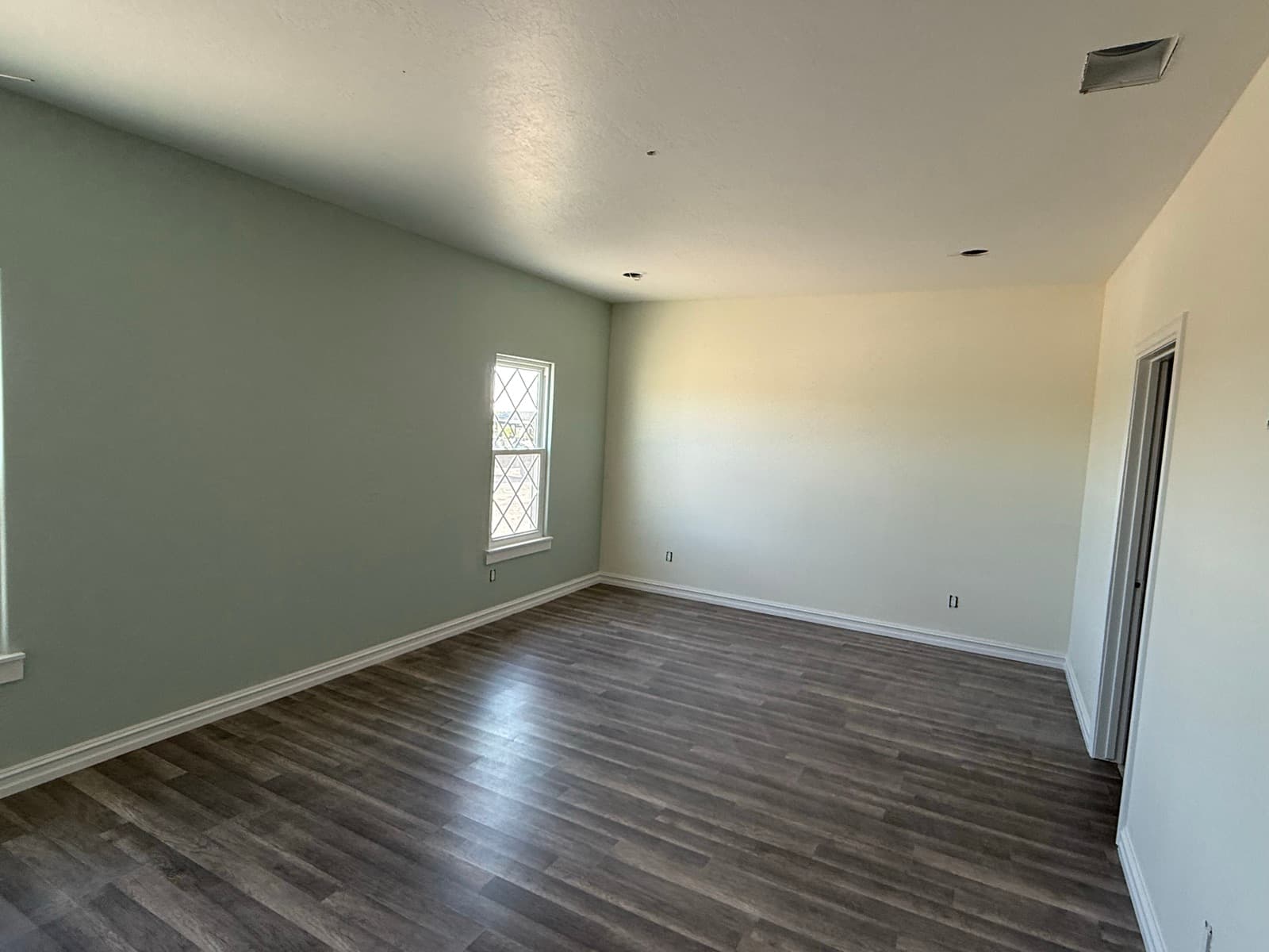 Bedroom with a sage-green accent wall